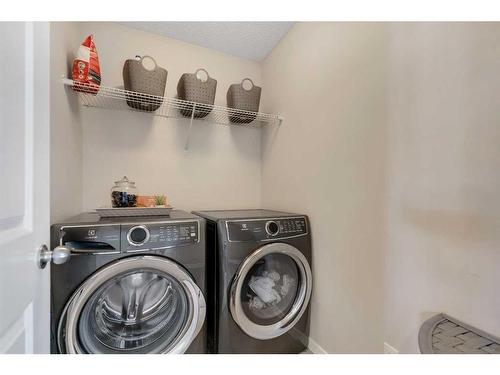 77 Fireside Cove, Cochrane, AB - Indoor Photo Showing Laundry Room