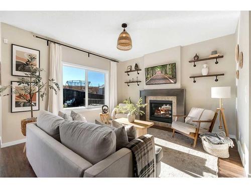 77 Fireside Cove, Cochrane, AB - Indoor Photo Showing Living Room With Fireplace