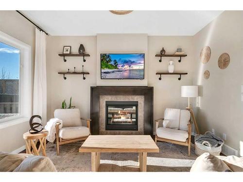 77 Fireside Cove, Cochrane, AB - Indoor Photo Showing Living Room With Fireplace