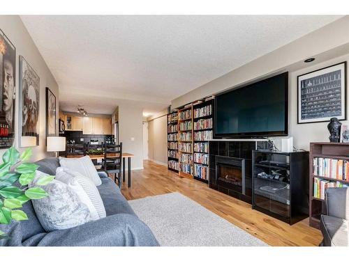 401-728 3 Avenue Nw, Calgary, AB - Indoor Photo Showing Living Room With Fireplace