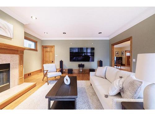 311 Roxboro Road Sw, Calgary, AB - Indoor Photo Showing Living Room With Fireplace