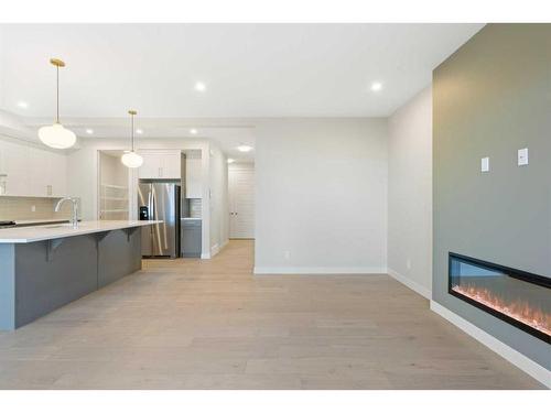 447 Crimson Ridge Place Nw, Calgary, AB - Indoor Photo Showing Kitchen With Fireplace