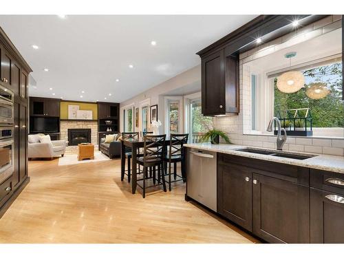 71 Edcath Road Nw, Calgary, AB - Indoor Photo Showing Kitchen With Fireplace With Double Sink