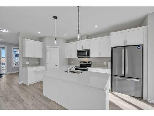 1131 Chinook Winds Circle Sw, Airdrie, AB - Indoor Photo Showing Kitchen With Stainless Steel Kitchen With Double Sink With Upgraded Kitchen