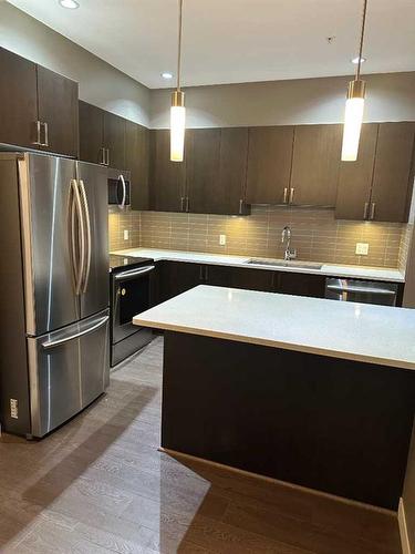 210-22 Auburn Bay Link Se, Calgary, AB - Indoor Photo Showing Kitchen With Stainless Steel Kitchen With Upgraded Kitchen