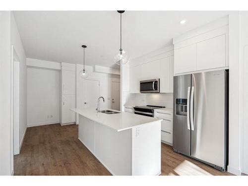 4112-111 Wolf Creek Drive Se, Calgary, AB - Indoor Photo Showing Kitchen With Stainless Steel Kitchen With Double Sink With Upgraded Kitchen