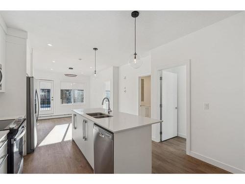 4112-111 Wolf Creek Drive Se, Calgary, AB - Indoor Photo Showing Kitchen With Stainless Steel Kitchen With Double Sink With Upgraded Kitchen