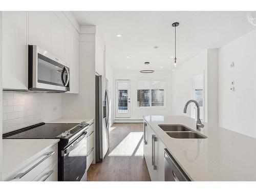 4112-111 Wolf Creek Drive Se, Calgary, AB - Indoor Photo Showing Kitchen With Stainless Steel Kitchen With Double Sink With Upgraded Kitchen