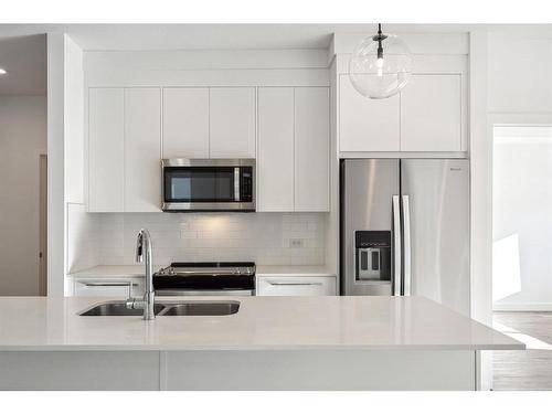 4112-111 Wolf Creek Drive Se, Calgary, AB - Indoor Photo Showing Kitchen With Stainless Steel Kitchen With Double Sink With Upgraded Kitchen