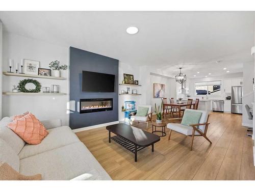 96 Magnolia Grove Se, Calgary, AB - Indoor Photo Showing Living Room With Fireplace