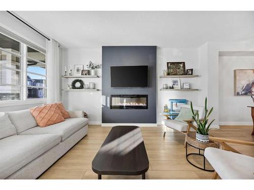 96 Magnolia Grove Se, Calgary, AB - Indoor Photo Showing Living Room With Fireplace