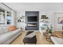 96 Magnolia Grove Se, Calgary, AB  - Indoor Photo Showing Living Room With Fireplace 