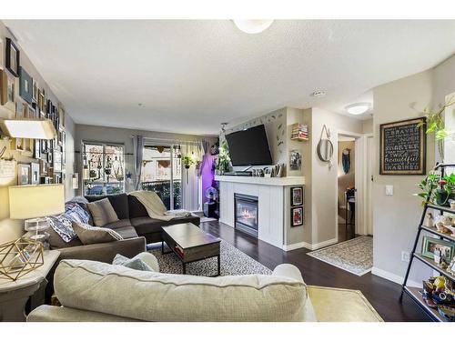 322-5115 Richard Road Sw, Calgary, AB - Indoor Photo Showing Living Room With Fireplace