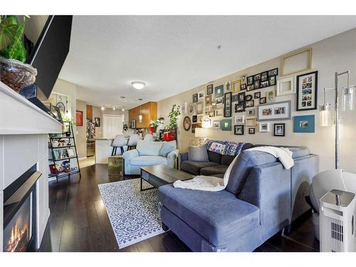 322-5115 Richard Road Sw, Calgary, AB - Indoor Photo Showing Living Room With Fireplace