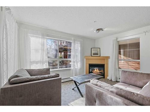 322-5115 Richard Road Sw, Calgary, AB - Indoor Photo Showing Living Room With Fireplace