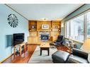 107 Hawkmount Close Nw, Calgary, AB  - Indoor Photo Showing Living Room With Fireplace 