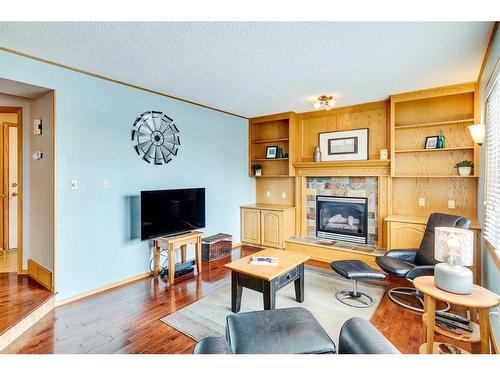 107 Hawkmount Close Nw, Calgary, AB - Indoor Photo Showing Living Room With Fireplace