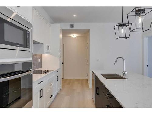 1301-55 Lucas Way Nw, Calgary, AB - Indoor Photo Showing Kitchen With Double Sink With Upgraded Kitchen