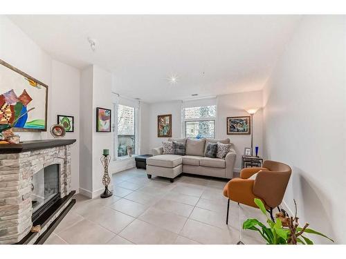 202-303 13 Avenue Sw, Calgary, AB - Indoor Photo Showing Living Room With Fireplace