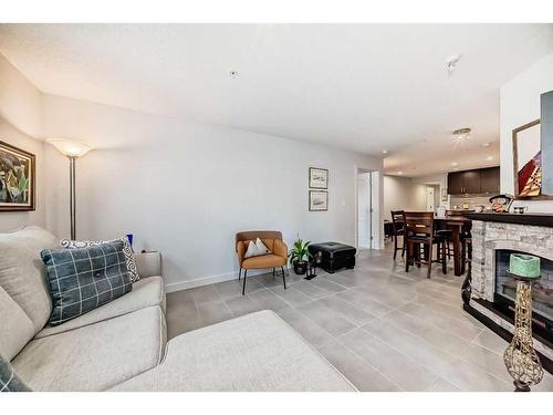 202-303 13 Avenue Sw, Calgary, AB - Indoor Photo Showing Living Room With Fireplace