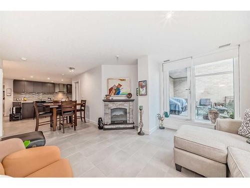 202-303 13 Avenue Sw, Calgary, AB - Indoor Photo Showing Living Room With Fireplace