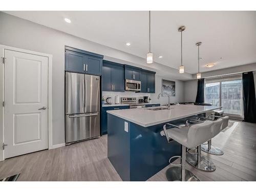 220-4350 Seton Drive Se, Calgary, AB - Indoor Photo Showing Kitchen With Stainless Steel Kitchen With Upgraded Kitchen