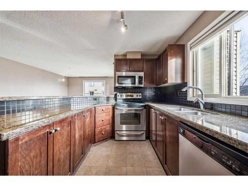 2215-16969 24 Street Sw, Calgary, AB - Indoor Photo Showing Kitchen With Double Sink