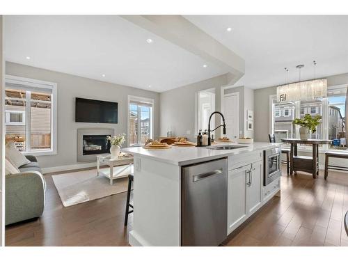 44 Windford Park Sw, Airdrie, AB - Indoor Photo Showing Kitchen With Fireplace With Upgraded Kitchen