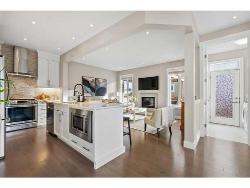 44 Windford Park Sw, Airdrie, AB - Indoor Photo Showing Kitchen With Fireplace With Upgraded Kitchen