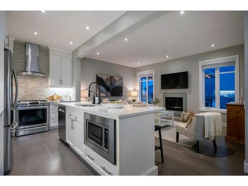 44 Windford Park Sw, Airdrie, AB - Indoor Photo Showing Kitchen With Fireplace With Upgraded Kitchen