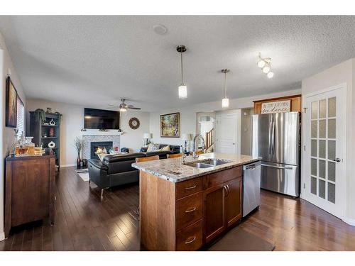 157 Sherwood Circle Nw, Calgary, AB - Indoor Photo Showing Kitchen With Fireplace With Double Sink