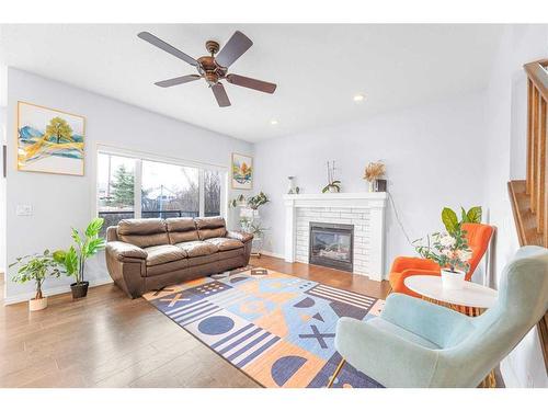 108 West Pointe Manor, Cochrane, AB - Indoor Photo Showing Living Room With Fireplace