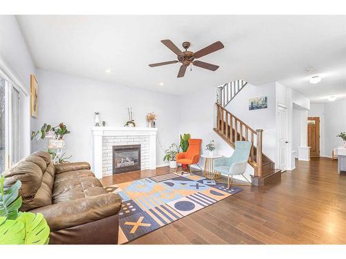 108 West Pointe Manor, Cochrane, AB - Indoor Photo Showing Living Room With Fireplace