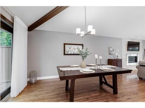 11 Woodlark Drive Sw, Calgary, AB - Indoor Photo Showing Dining Room With Fireplace