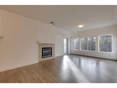 319-10 Discovery Ridge Close Sw, Calgary, AB - Indoor Photo Showing Living Room With Fireplace