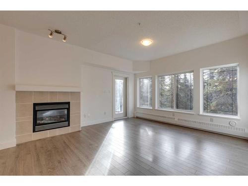 319-10 Discovery Ridge Close Sw, Calgary, AB - Indoor Photo Showing Living Room With Fireplace