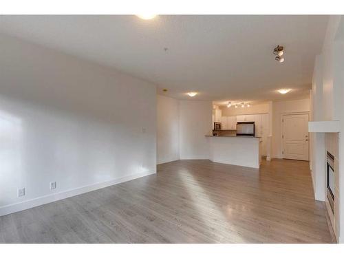 319-10 Discovery Ridge Close Sw, Calgary, AB - Indoor Photo Showing Other Room With Fireplace