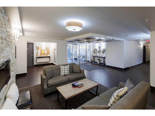 410-103 Valley Ridge Manor Nw, Calgary, AB - Indoor Photo Showing Living Room With Fireplace