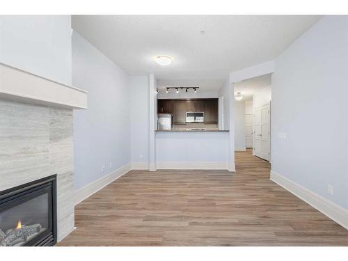 202-518 33 Street Nw, Calgary, AB - Indoor Photo Showing Living Room With Fireplace