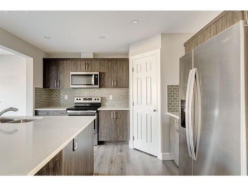 41 Hillcrest Square Sw, Airdrie, AB - Indoor Photo Showing Kitchen With Stainless Steel Kitchen With Double Sink With Upgraded Kitchen