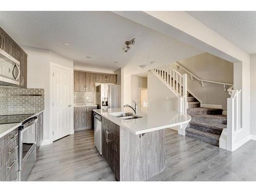 41 Hillcrest Square Sw, Airdrie, AB - Indoor Photo Showing Kitchen With Double Sink