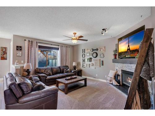 141 Somerset Way Sw, Calgary, AB - Indoor Photo Showing Living Room With Fireplace