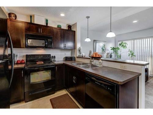 66 Country Village Villas Ne, Calgary, AB - Indoor Photo Showing Kitchen With Double Sink