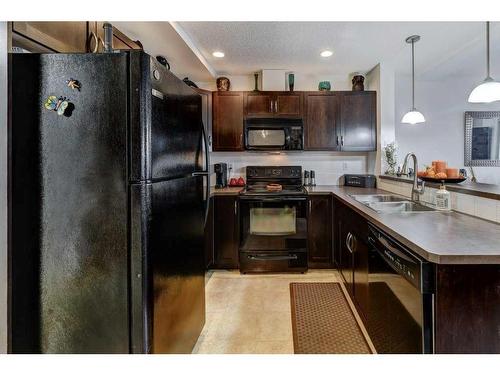 66 Country Village Villas Ne, Calgary, AB - Indoor Photo Showing Kitchen With Double Sink