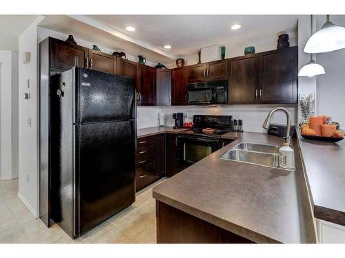 66 Country Village Villas Ne, Calgary, AB - Indoor Photo Showing Kitchen With Double Sink