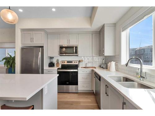 109-525 River Heights Drive, Cochrane, AB - Indoor Photo Showing Kitchen With Double Sink With Upgraded Kitchen