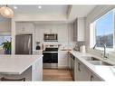 109-525 River Heights Drive, Cochrane, AB  - Indoor Photo Showing Kitchen With Double Sink With Upgraded Kitchen 