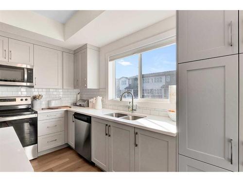 109-525 River Heights Drive, Cochrane, AB - Indoor Photo Showing Kitchen With Double Sink