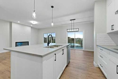 32 Ranchers View, Okotoks, AB - Indoor Photo Showing Kitchen With Double Sink With Upgraded Kitchen