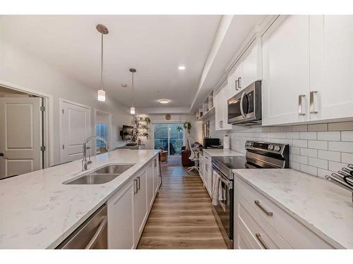 104-200 Harvest Hills Place Ne, Calgary, AB - Indoor Photo Showing Kitchen With Double Sink With Upgraded Kitchen